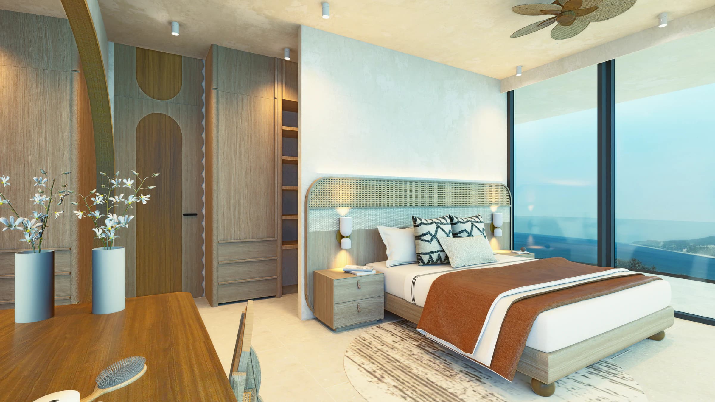Primary bedroom in a two-bedroom residence with the ocean visible through full-height glass
