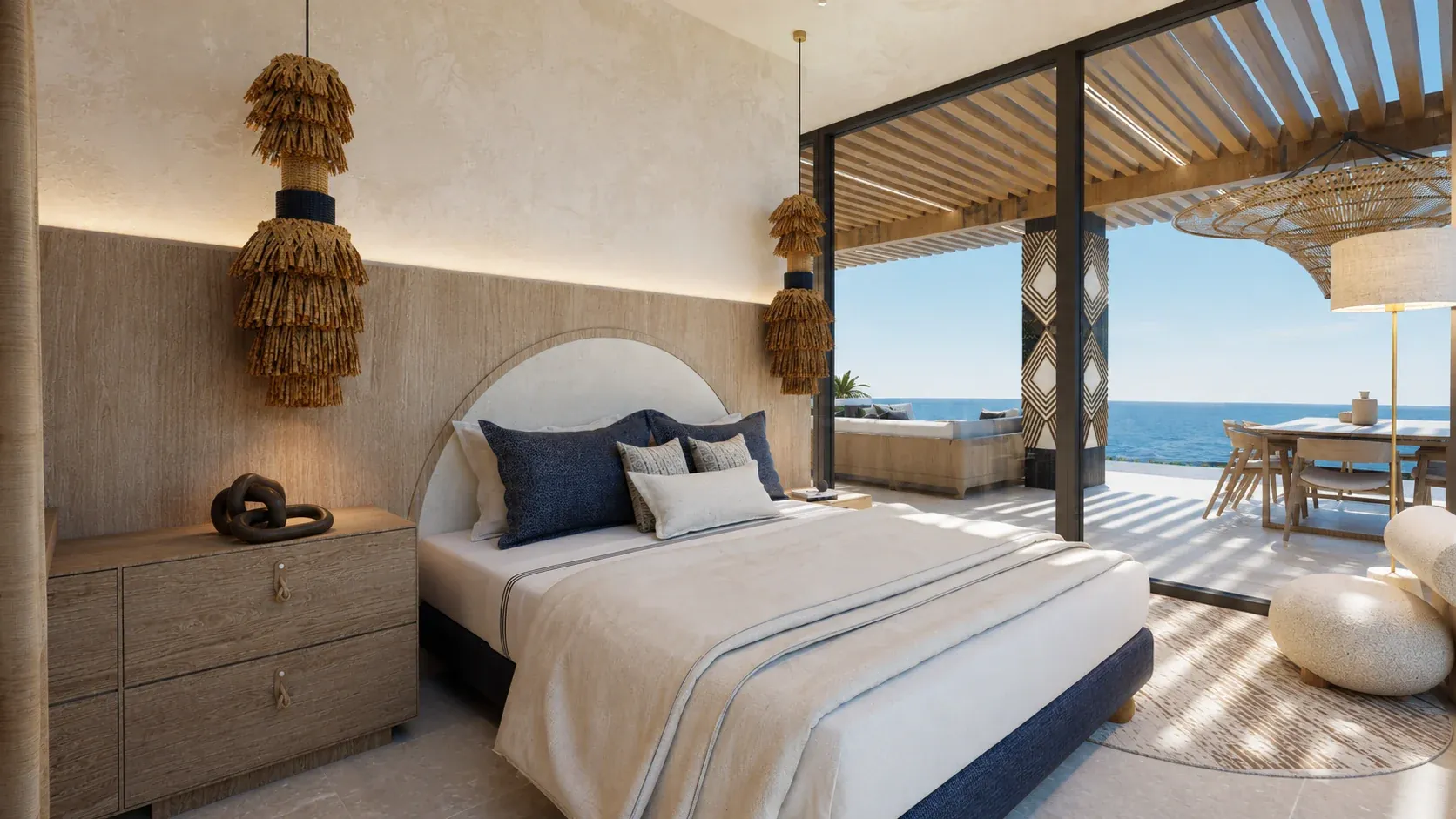 Nayari bedroom opening to a furnished terrace with the Pacific beyond